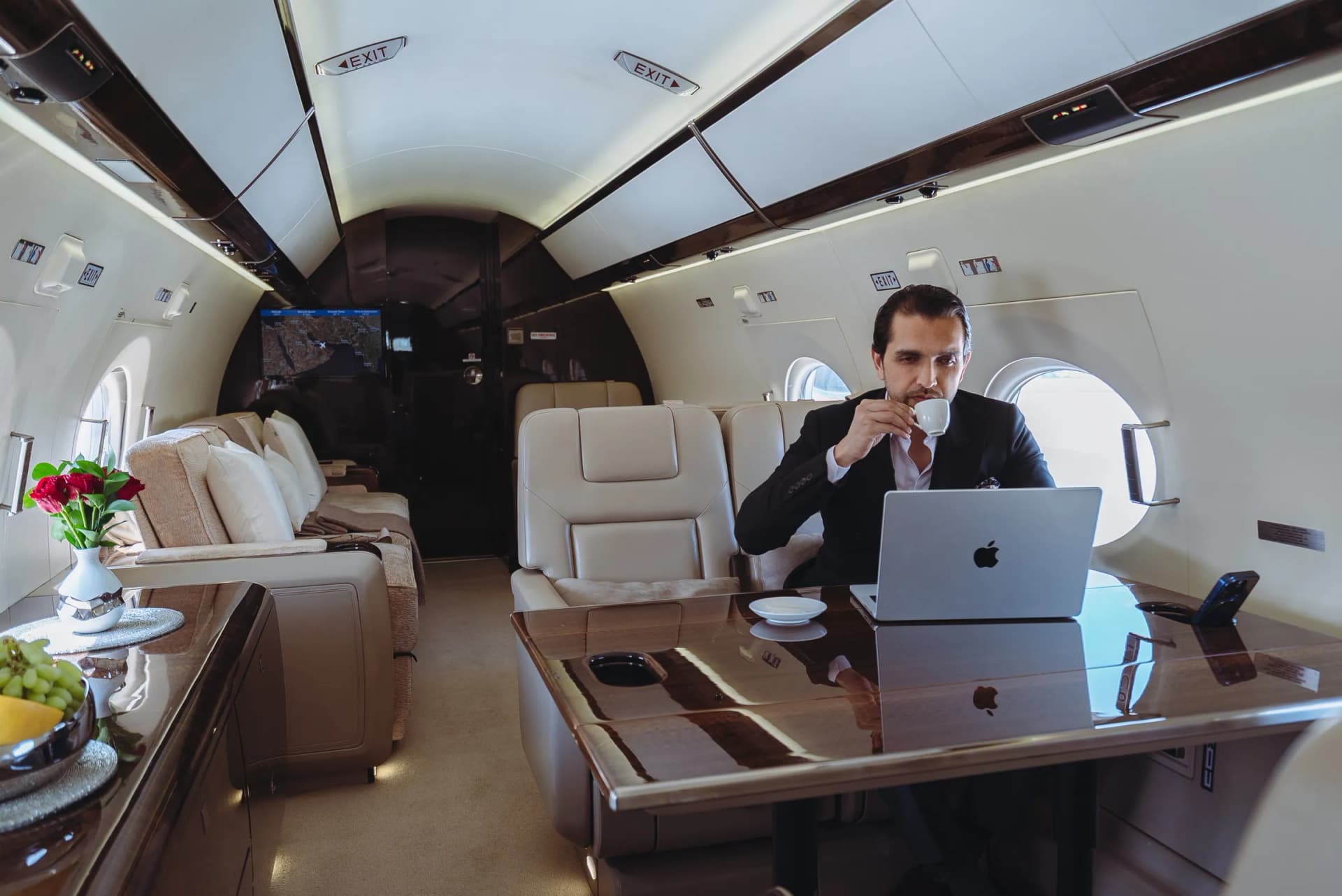 A passenger working on a laptop at the Gulfstream G450 conference table