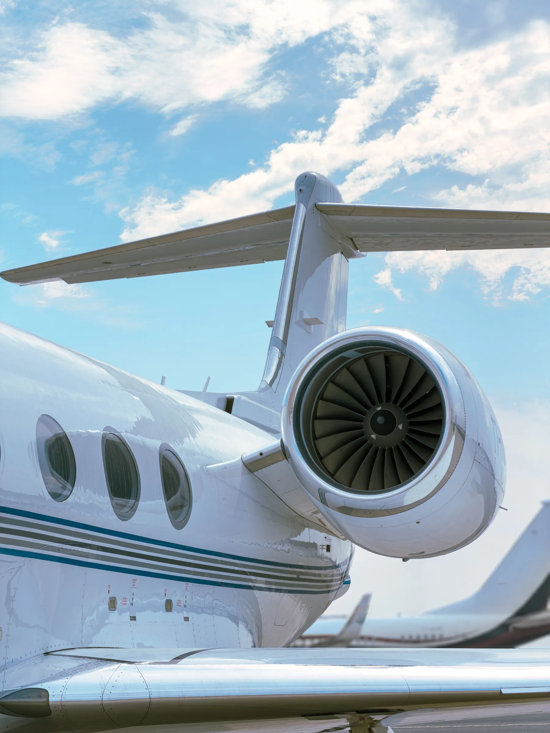 The Gulfstream G450’s rear engine and T-tail against a blue sky