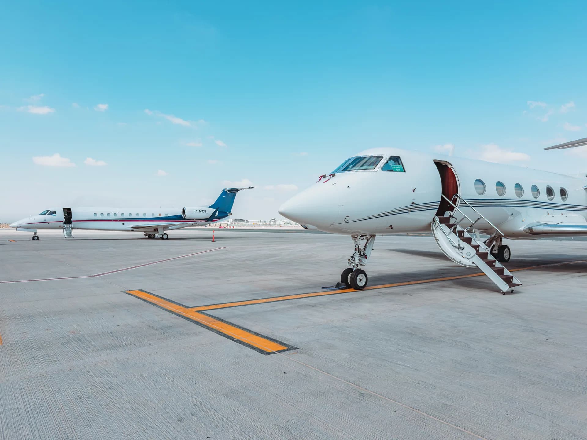 Gulfstream G450 with its airstair down on the Dubai ramp, Embraer Legacy 650 T7-MIDB behind